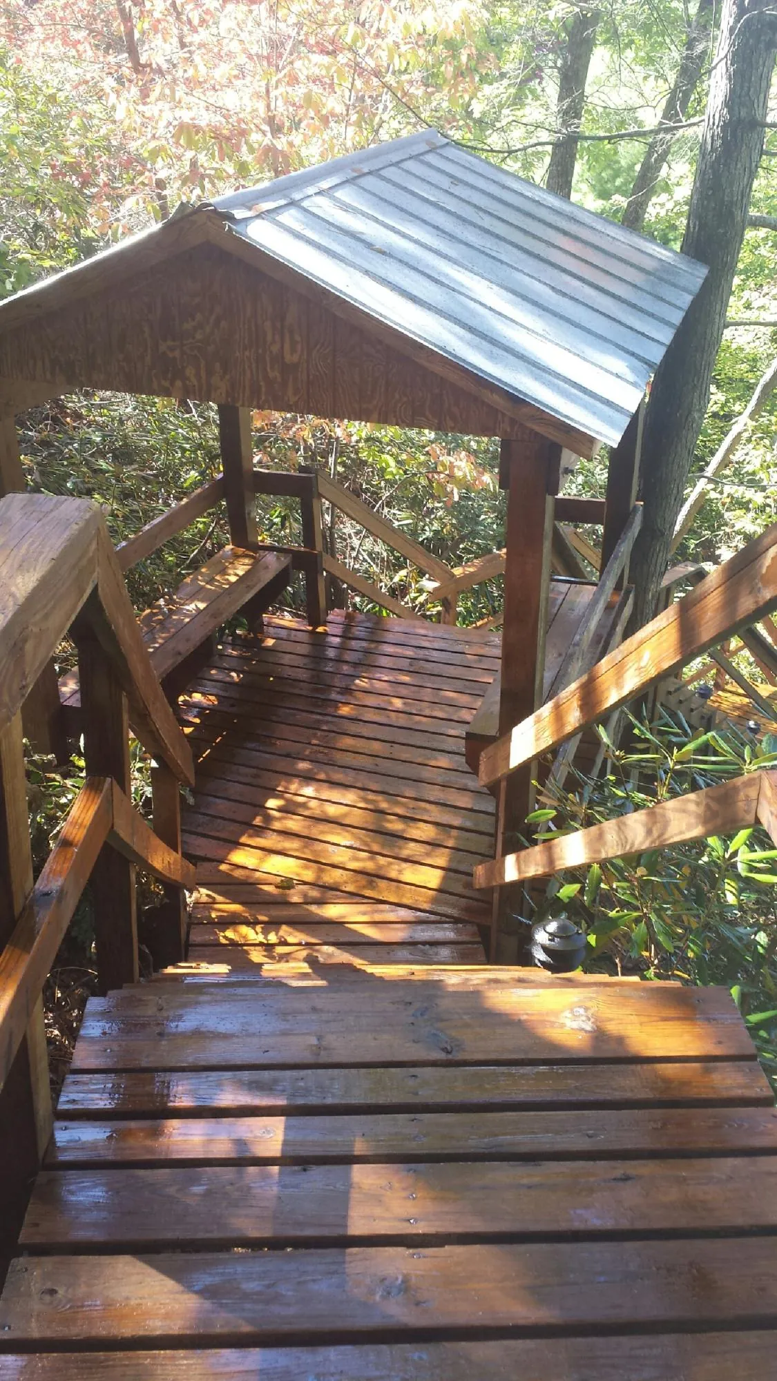 Freshly stained wood walkway and covered shelter with a metal roof in New Lisbon
